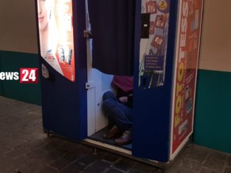 Clochard senza nome dorme dentro cabina delle fototessere, a Perugia